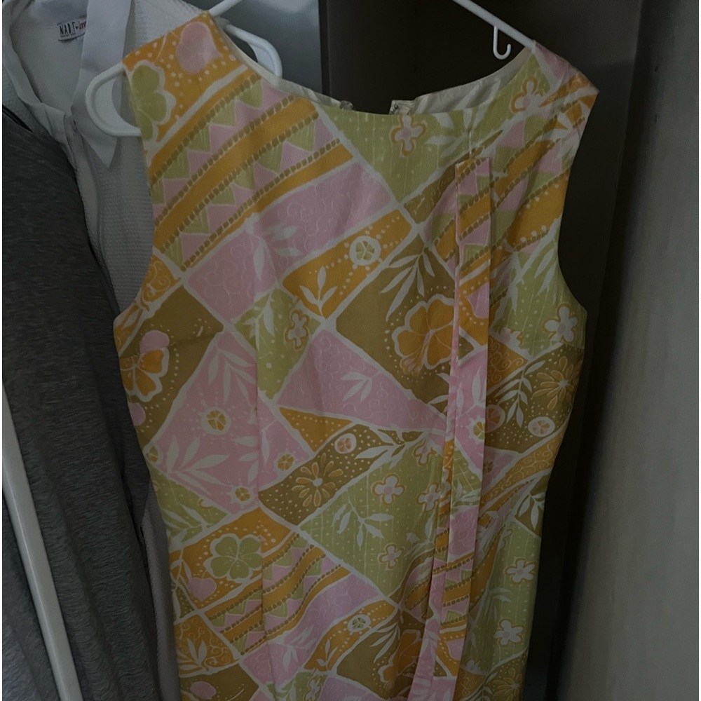 Vintage flowery dress with no sleeves. Bought new and worned once.